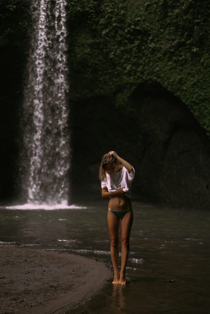 young-woman-travels-around-island-taking-pictures-waterfall